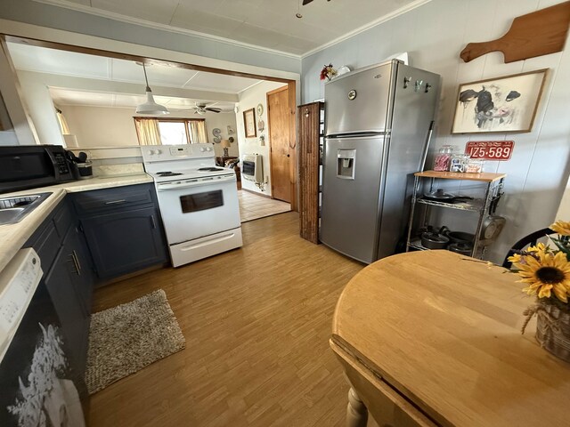 kitchen with ornamental molding, white range with electric stovetop, stainless steel fridge, black microwave, and ceiling fan