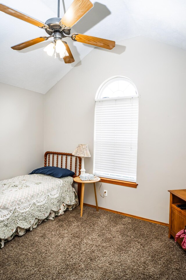 carpeted bedroom with baseboards, lofted ceiling, and a ceiling fan