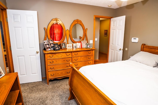 bedroom with dark colored carpet