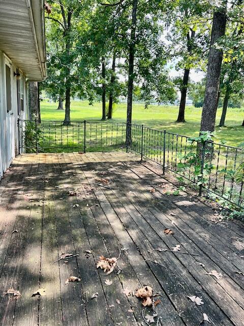 wooden terrace with a yard