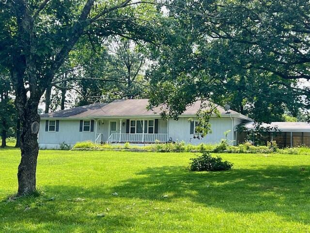 ranch-style house featuring a porch and a front yard