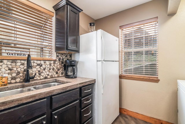 kitchen featuring a sink, decorative backsplash, and plenty of natural light