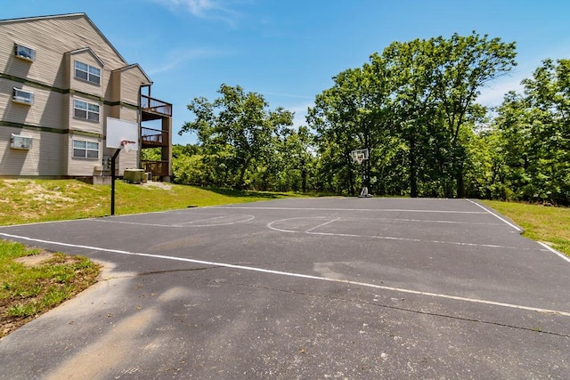 view of basketball court with community basketball court and a yard