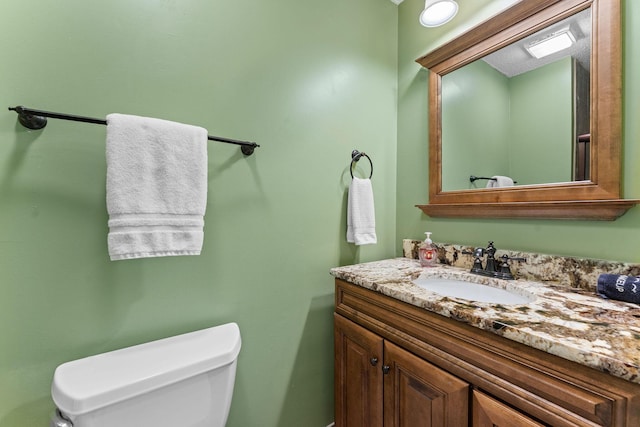 bathroom with toilet and vanity