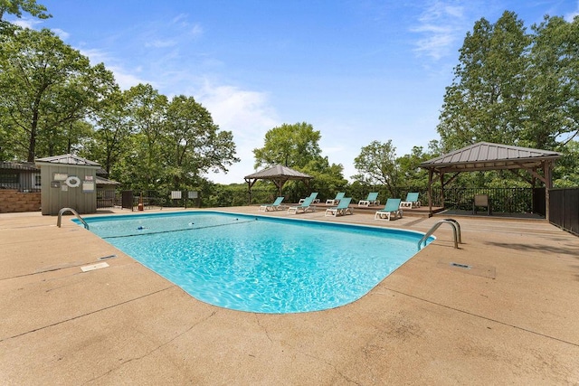 pool featuring a gazebo, a patio, and fence