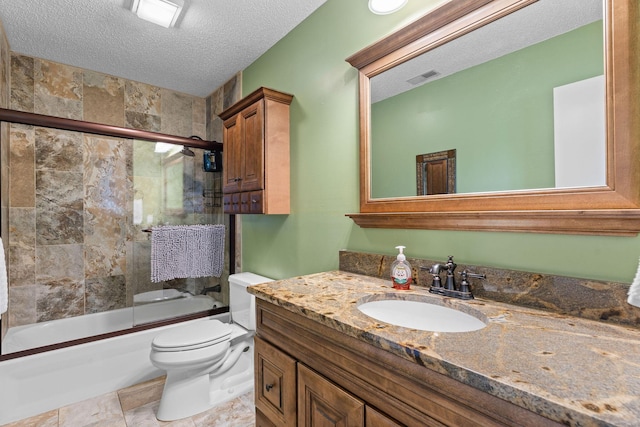 full bath featuring visible vents, bath / shower combo with glass door, toilet, vanity, and a textured ceiling