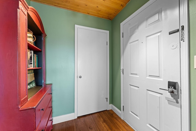 interior space with baseboards, dark wood-type flooring, and wood ceiling