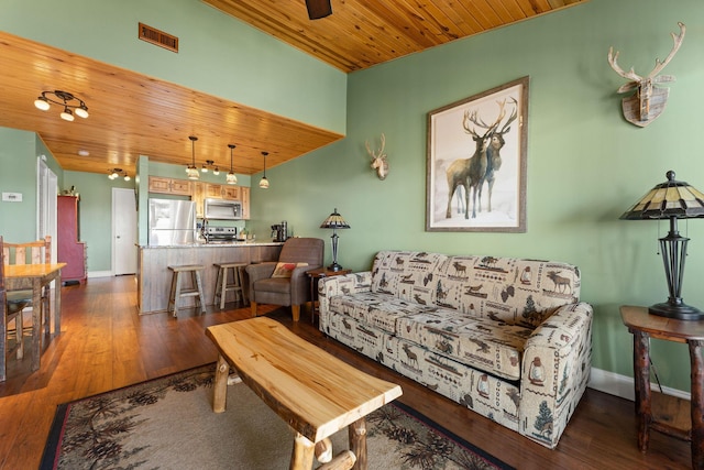 living area with visible vents, baseboards, wood ceiling, and hardwood / wood-style floors