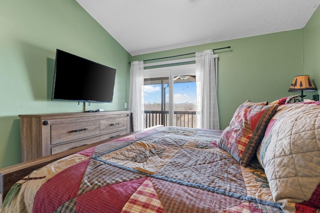 bedroom featuring a textured ceiling, vaulted ceiling, and access to outside