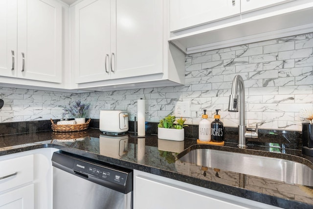 kitchen with backsplash, dishwasher, white cabinetry, and a sink