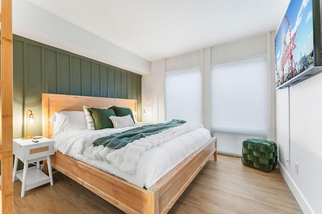 bedroom featuring baseboards and wood finished floors