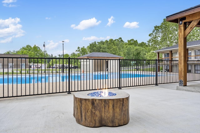 view of swimming pool featuring a patio area, fence, and a fenced in pool