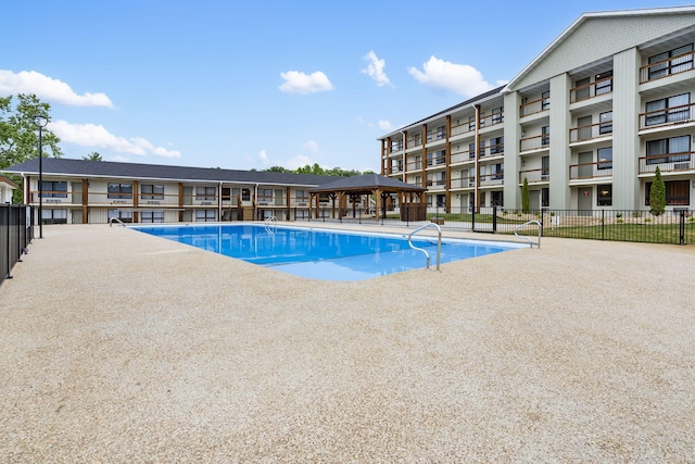 pool featuring a gazebo and fence