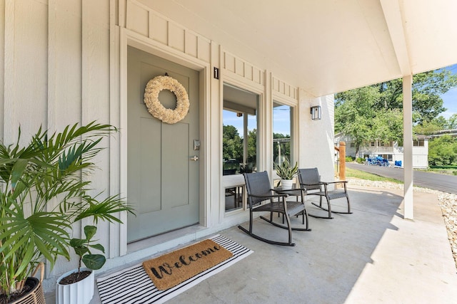 view of exterior entry featuring a porch