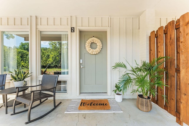 doorway to property featuring board and batten siding