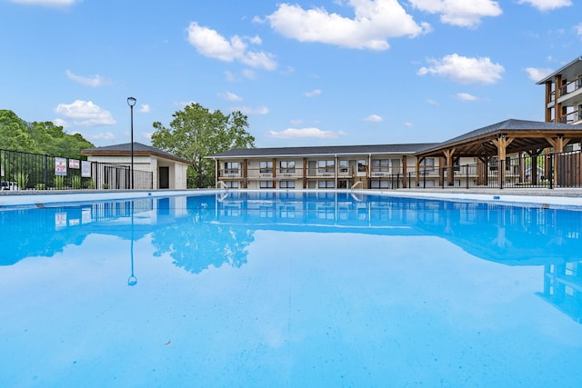 view of swimming pool with fence