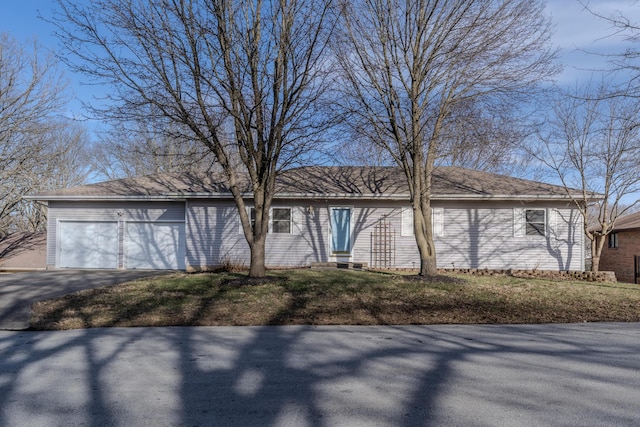 ranch-style house with driveway and an attached garage