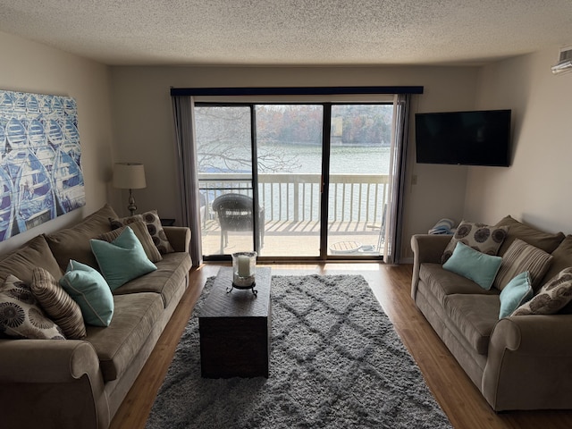 living area with wood finished floors and a textured ceiling