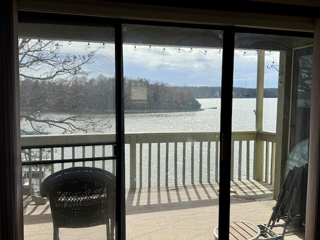 sunroom / solarium featuring a water view