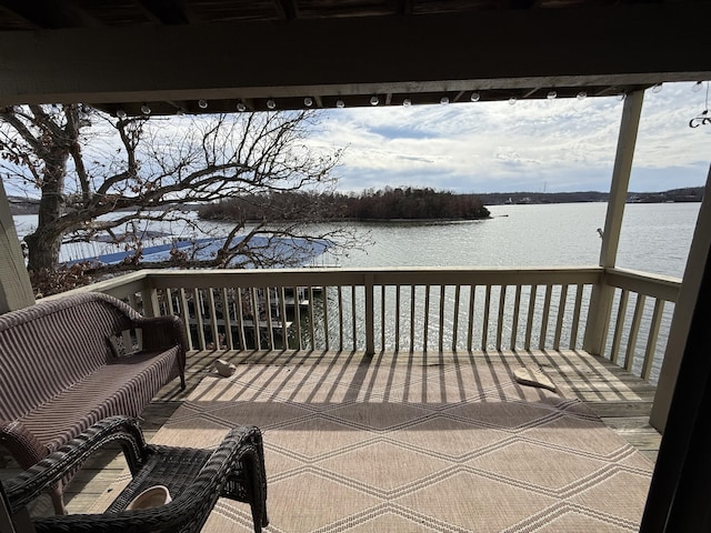 wooden deck featuring a water view