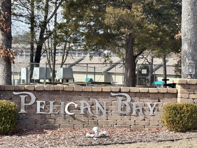 community / neighborhood sign featuring fence