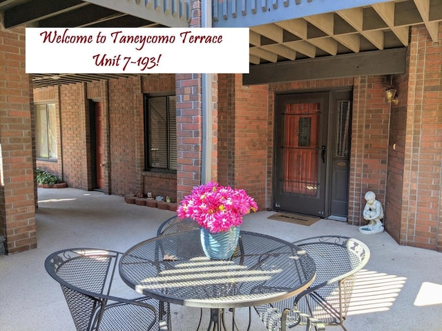 property entrance featuring brick siding