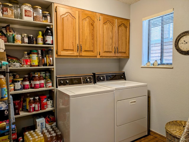 washroom featuring cabinet space and washing machine and dryer