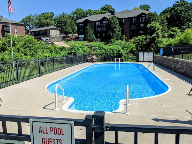 pool featuring a patio area and fence