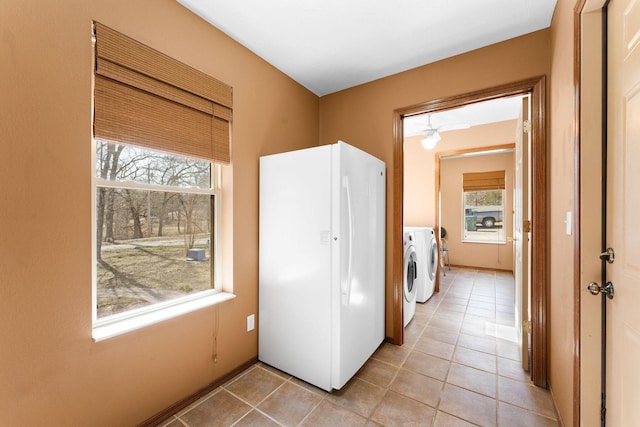 clothes washing area with laundry area, light tile patterned flooring, and independent washer and dryer