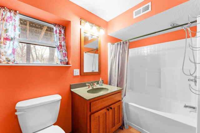 full bath featuring vanity, shower / bath combination with curtain, toilet, and visible vents