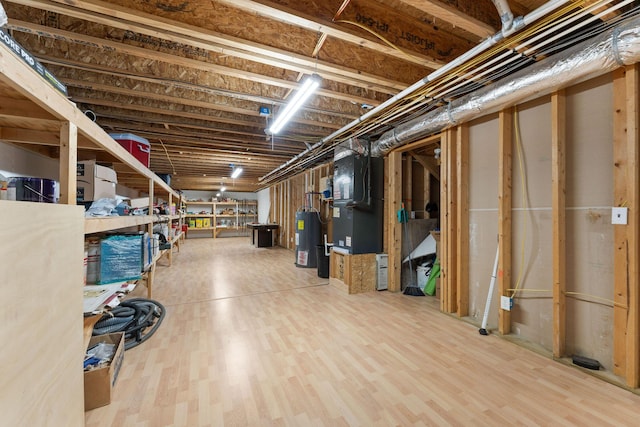 unfinished basement with water heater, heating unit, and wood finished floors