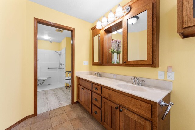 bathroom featuring double vanity, baseboards, and a sink