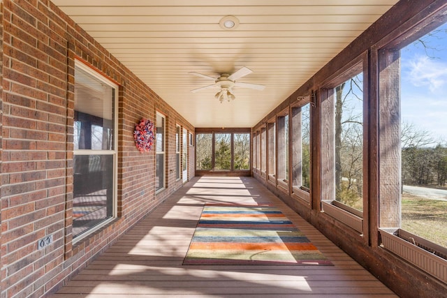 unfurnished sunroom with a ceiling fan