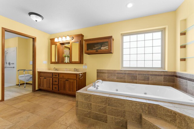 full bath with double vanity, a jetted tub, toilet, and a sink