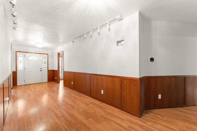 270 Craig Rd, Walnut Shade, MO 65771 - entryway with wooden walls, light wood finished floors, rail lighting, and wainscoting