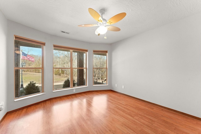 270 Craig Rd, Walnut Shade, MO 65771 - empty room with wood finished floors, visible vents, a ceiling fan, and baseboards