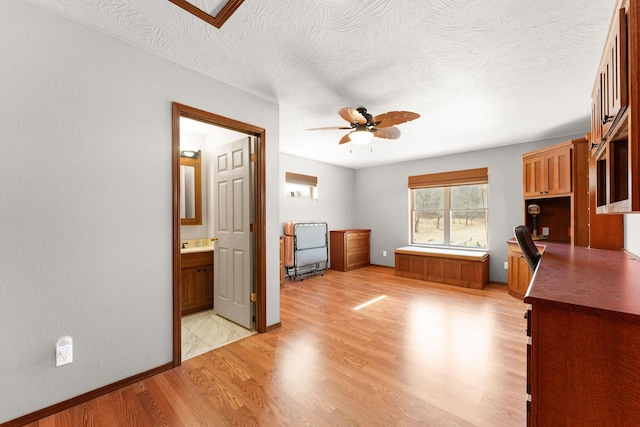 270 Craig Rd, Walnut Shade, MO 65771 - interior space featuring a textured ceiling, a sink, light wood-style floors, ensuite bathroom, and baseboards