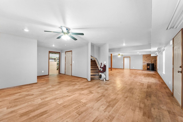 270 Craig Rd, Walnut Shade, MO 65771 - unfurnished living room featuring light wood-style flooring, ceiling fan, recessed lighting, a fireplace, and stairs
