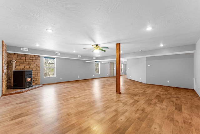 270 Craig Rd, Walnut Shade, MO 65771 - below grade area featuring recessed lighting, light wood-style flooring, visible vents, a ceiling fan, and a wood stove