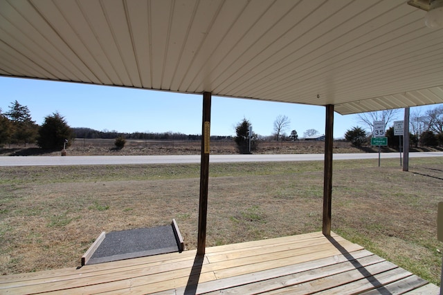 wooden terrace with a lawn