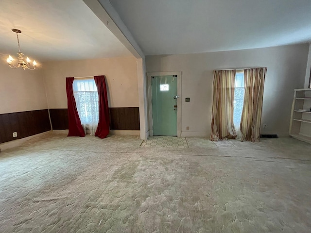 104 N High St, Neosho, MO 64850 - entryway with wooden walls, a notable chandelier, and a wainscoted wall