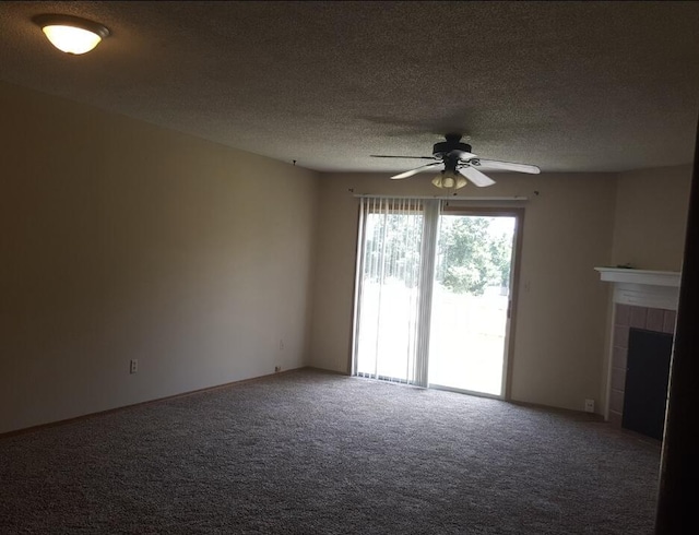 unfurnished living room featuring a fireplace, a textured ceiling, carpet, and a ceiling fan