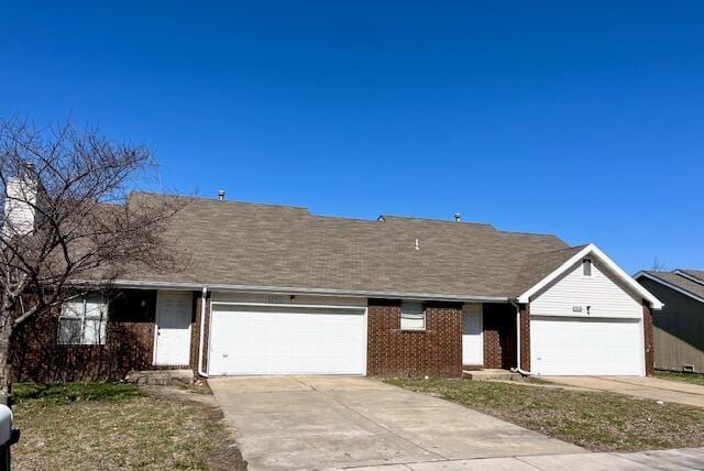 single story home featuring brick siding, driveway, a garage, and roof with shingles