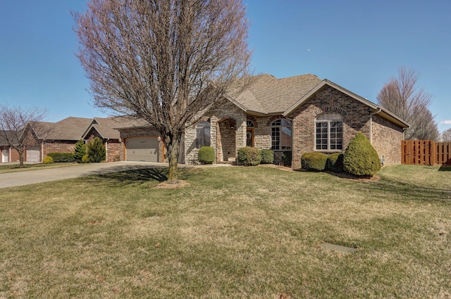 view of front of property with fence, driveway, a front lawn, a garage, and brick siding