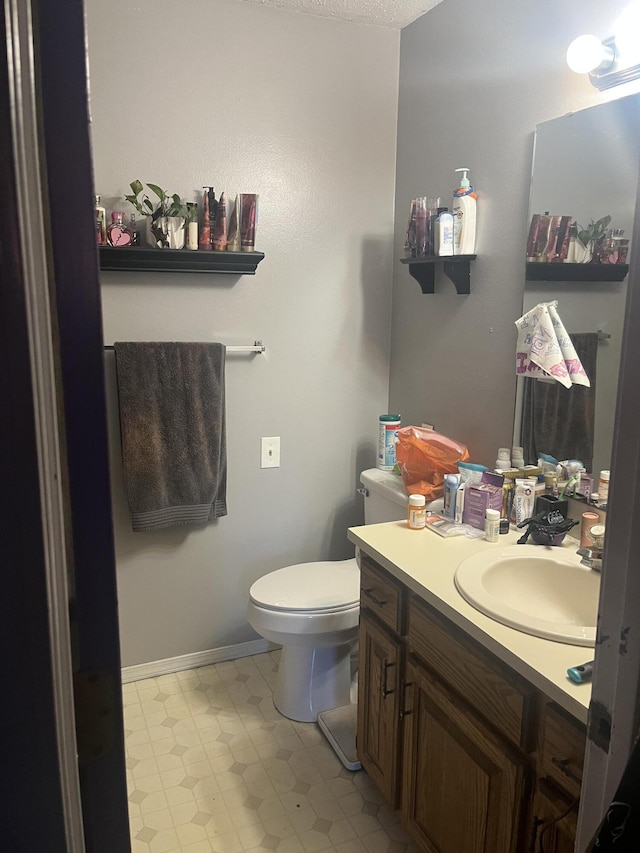 3494 S Christy Ct, Springfield, MO 65807 - half bathroom with vanity, toilet, and baseboards