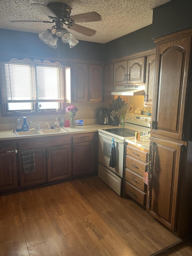 3494 S Christy Ct, Springfield, MO 65807 - kitchen featuring wood finished floors, electric range, light countertops, under cabinet range hood, and a textured ceiling