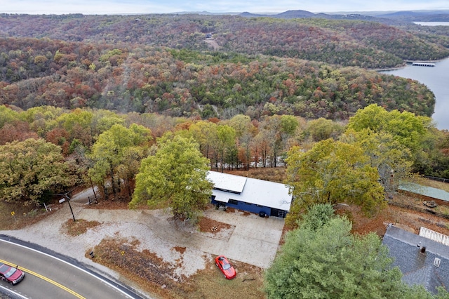 birds eye view of property featuring a view of trees and a water view