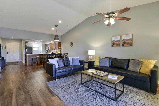 living room featuring ceiling fan, baseboards, lofted ceiling, and dark wood-style floors