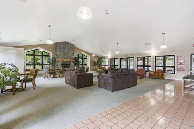 carpeted living area with a large fireplace and high vaulted ceiling