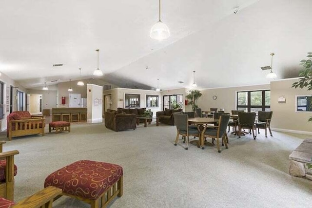 dining area featuring visible vents, baseboards, carpet, and vaulted ceiling